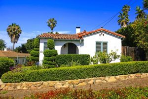 Spanish-style white house with manicured hedges