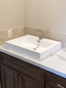 White rectangular vessel sink on marble vanity