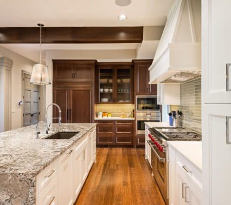 Modern kitchen with marble island and wood cabinetry
