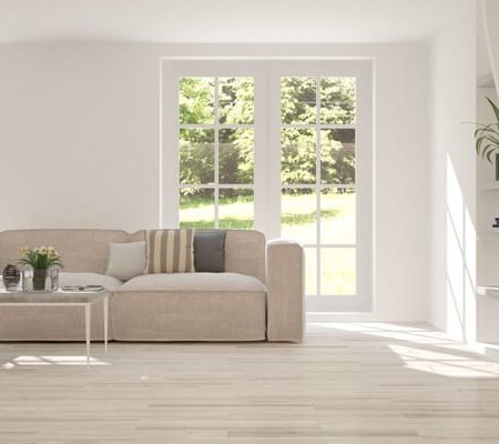 Bright minimalist living room with beige sofa